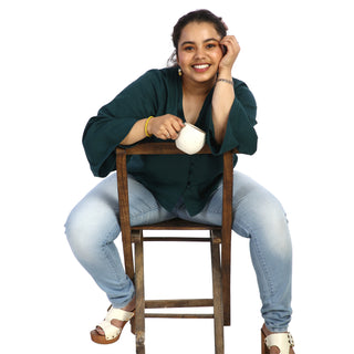 Button-up emerald green top with chair